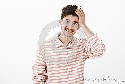 Guy saying sorry, admitting fault. Portrait of ashamed insecure attractive male model with beard and moustache, touching Stock Photo