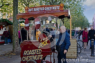 Guy Selling Hot Roasted Chestnuts at a Christmas Market. Editorial Stock Photo
