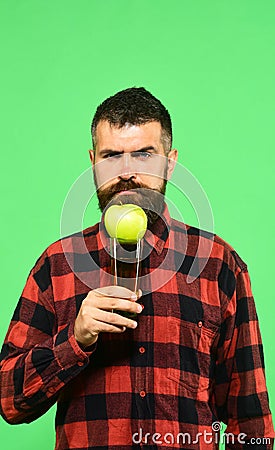 Guy shows harvest product. Man holds glass of apple juice Stock Photo