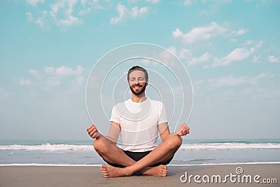 The guy sits on the seashore in the lotus position and meditates. Stock Photo