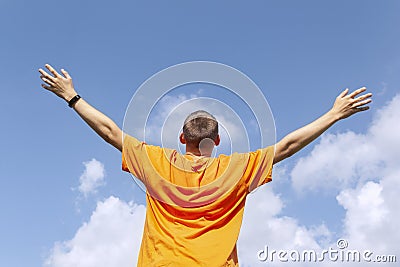 The guy stands with his arms outstretched to the sky Stock Photo