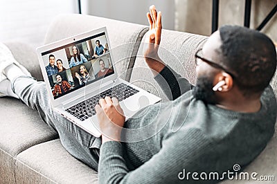 A guy talking online with friends via video call Stock Photo