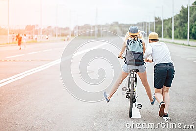 Guy teach his girl to ride a bike Stock Photo