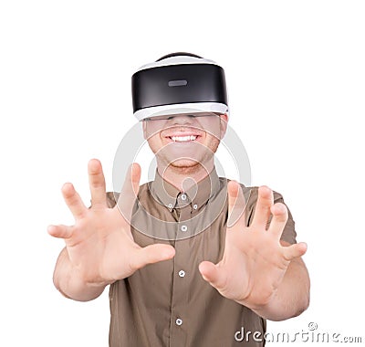 A guy trying to touch or embrace with hands virtual objects in a digital simulation. A young man in a virtual glasses. VR device. Stock Photo