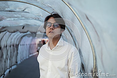 Guy in tunnel in white shirt Stock Photo