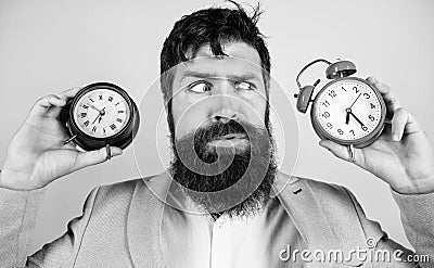 Guy unshaven puzzled face having problems with changing time. Changing time zones affect health. Time zone. Does Stock Photo