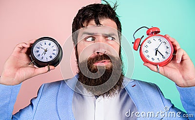 Guy unshaven puzzled face having problems with changing time. Changing time zones affect health. Time zone. Does Stock Photo