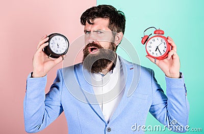 Guy unshaven puzzled face having problems with changing time. Time zone. Does changing clock mess with your health. Man Stock Photo