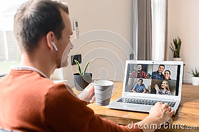 A guy is using laptop for video call, zoom Stock Photo