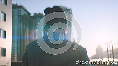 The guy walks on the roof at sunrise stock video footage The guy walks on the roof at sunrise stock video footage