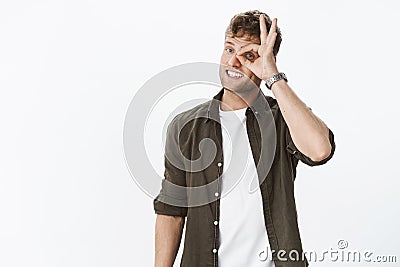 Guy watching you. Friendly and cute funny boyfriend with blond hair and bristle showing okay gesture, no problem, making Stock Photo