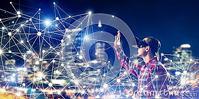 Guy wearing checked shirt and virtual mask reaching hand to feel Stock Photo