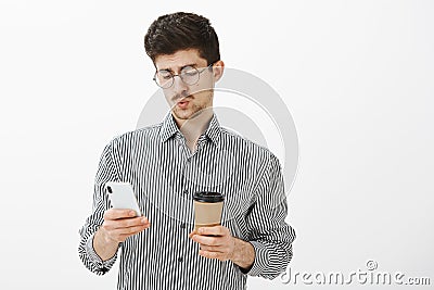 Guy whistling, seeing troubling message from boss. Portrait of indifferent handsome european male model with beard and Stock Photo