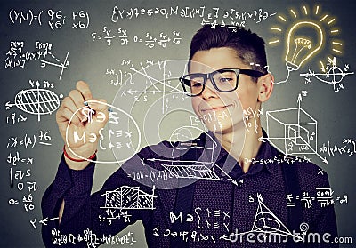 Guy writing high school maths and science formulas Stock Photo