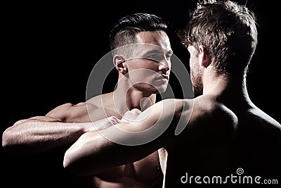 Guys fighting, bare nude torso of two men. Naked body, nude bare torso. Stock Photo