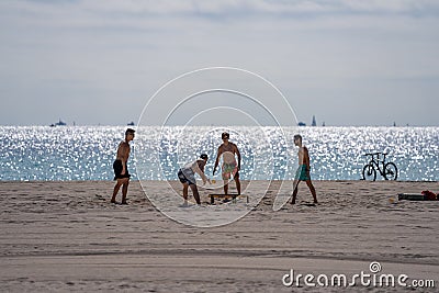 Guys playing Spikeball on the beach Miami Spring Break scene Editorial Stock Photo