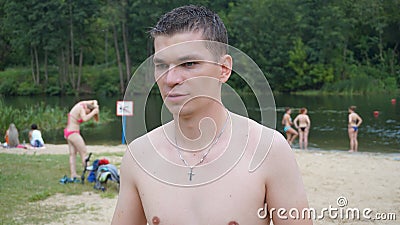 Guys relax on the beach standing on the shore Stock Photo