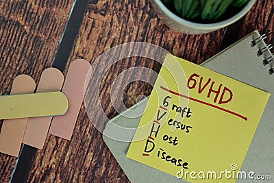 GVHD - Graft Versus Host Disease write on sticky notes isolated on Wooden Table Stock Photo
