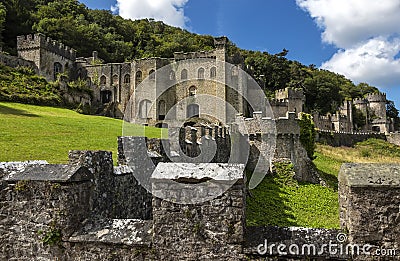 Gwrych castle in Wales UK surrounded by trees and foliage on hill side ruins Stock Photo