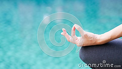 Gyan mudra hand yoga calm peace blue water background Stock Photo