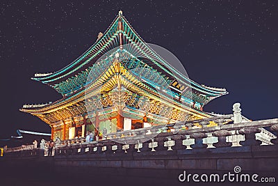 Gyeongbokgung main palace at night with writing in chinese meaning - Stock Photo