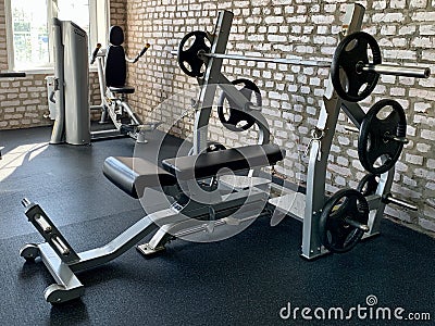 Gym for bodybuilding. Heavy dumbbells and exercise equipment. Barbells and equipment for athletes Editorial Stock Photo