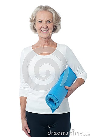 Gym instructor holding blue exercise mat Stock Photo