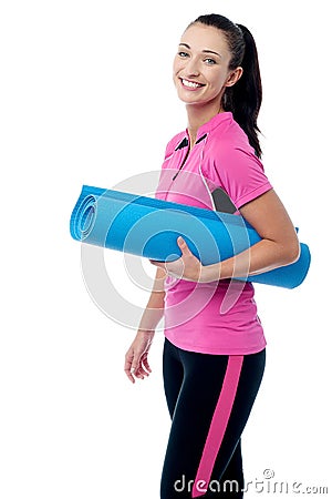 Gym instructor holding blue mat Stock Photo