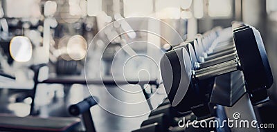 Gym interior background of dumbbells on barbell in fitness and workout room Stock Photo