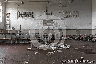 Gymnasium with stacked desks in abandoned high school Stock Photo