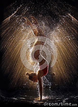 Gymnast in the spray of water Stock Photo