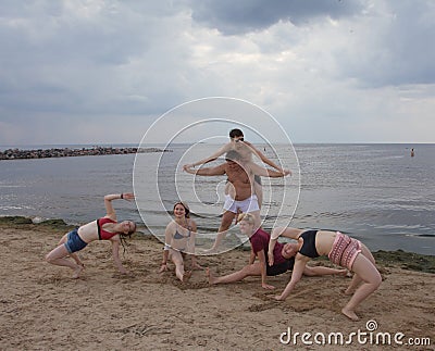 Gymnastic pyramid. youth fun games on the beach. Editorial Stock Photo