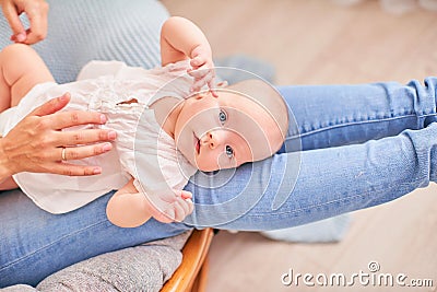 Gymnastics baby. woman doing exercises with baby for its development. massage a small newborn baby Stock Photo