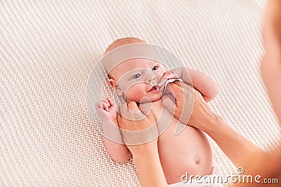 Gymnastics baby. woman doing exercises with baby for its development. massage a small newborn baby Stock Photo