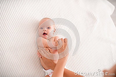 Gymnastics baby. woman doing exercises with child for its development Stock Photo