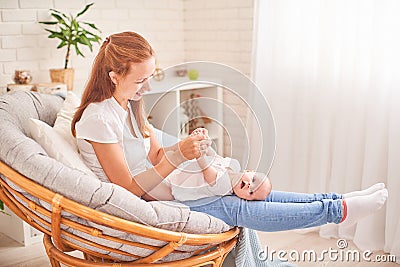 Gymnastics baby. woman doing exercises with baby for its development. massage a small newborn baby Stock Photo