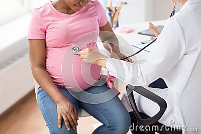 Gynecologist doctor and pregnant woman at hospital Stock Photo