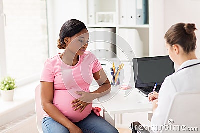 Gynecologist doctor and pregnant woman at hospital Stock Photo