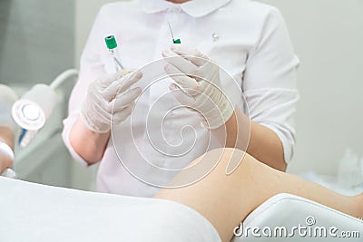 Gynecologist holding empty plasmolifting device before using it Stock Photo