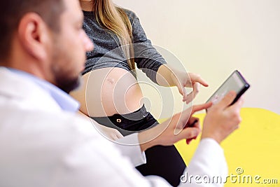 Gynecologist showing echo photo to pregnant woman Stock Photo