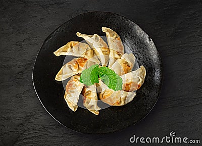 Gyoza Chinese Dumplings Top View, Vegetable Jiaozi, Chicken Momo Pile, Asian Gyoza Portion on Black Stock Photo