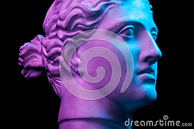 Gypsum copy of ancient statue Diana head isolated on black background. Plaster sculpture man face. Stock Photo