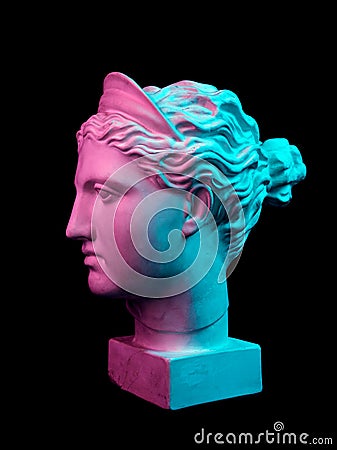 Gypsum copy of ancient statue Diana head isolated on black background. Plaster sculpture woman face. Stock Photo