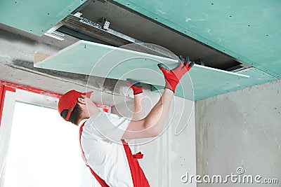 Gypsum plasterboard construction work at suspended ceiling Stock Photo