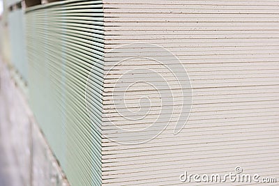 Gypsum plasterboard in the pack. The stack of gypsum board preparing for construction. Pallet with plasterboard in the building Stock Photo