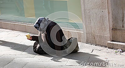 Gypsy asks for alms on the street Editorial Stock Photo