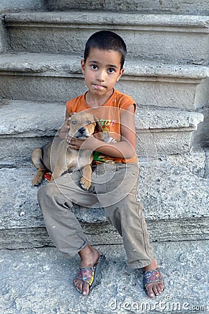 A gypsy boy holds a puppy in Edirne in northern Turkey. Editorial Stock Photo