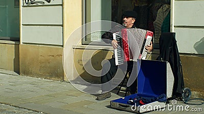 OLOMOUC, CZECH REPUBLIC, FEBRUARY 29, 2019: Gypsy man in city begging money into a cup, authentic plays music the Editorial Stock Photo