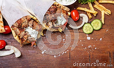 Gyro pita, shawarma, take away, street food. Traditional greek turkish, meat food on wooden table Stock Photo