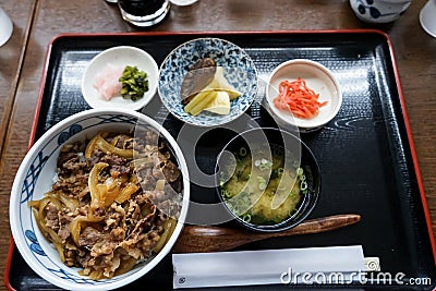 Gyudon or beef bowl, a japanese popular dish, in combo set including rice bowl, miso soup, pickle and other side dishes Stock Photo